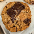 Chocolate chip cookies on a baking sheet with a fork